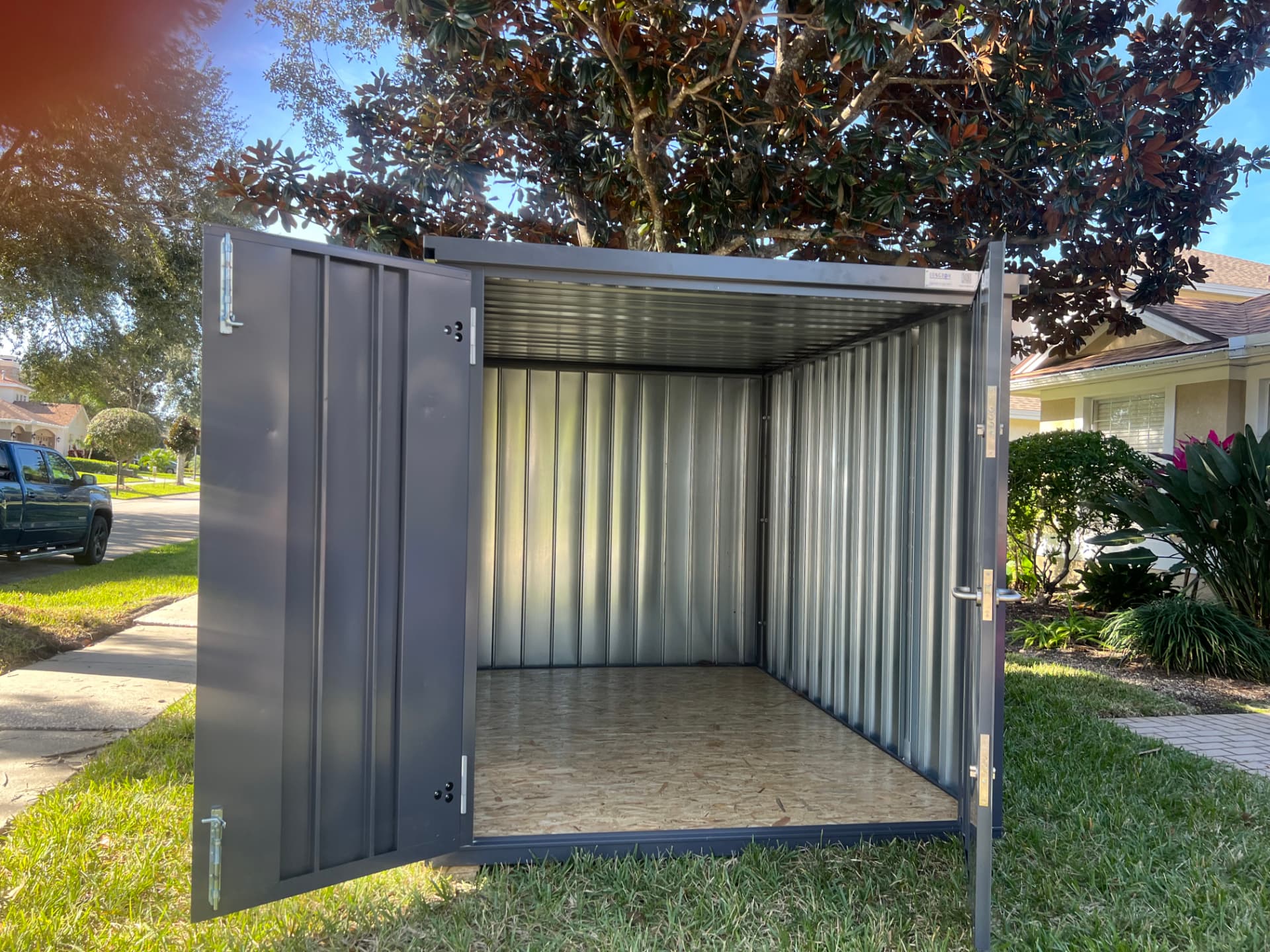 Longbox interior showing galvanized ribbed walls and plywood floor with doors open